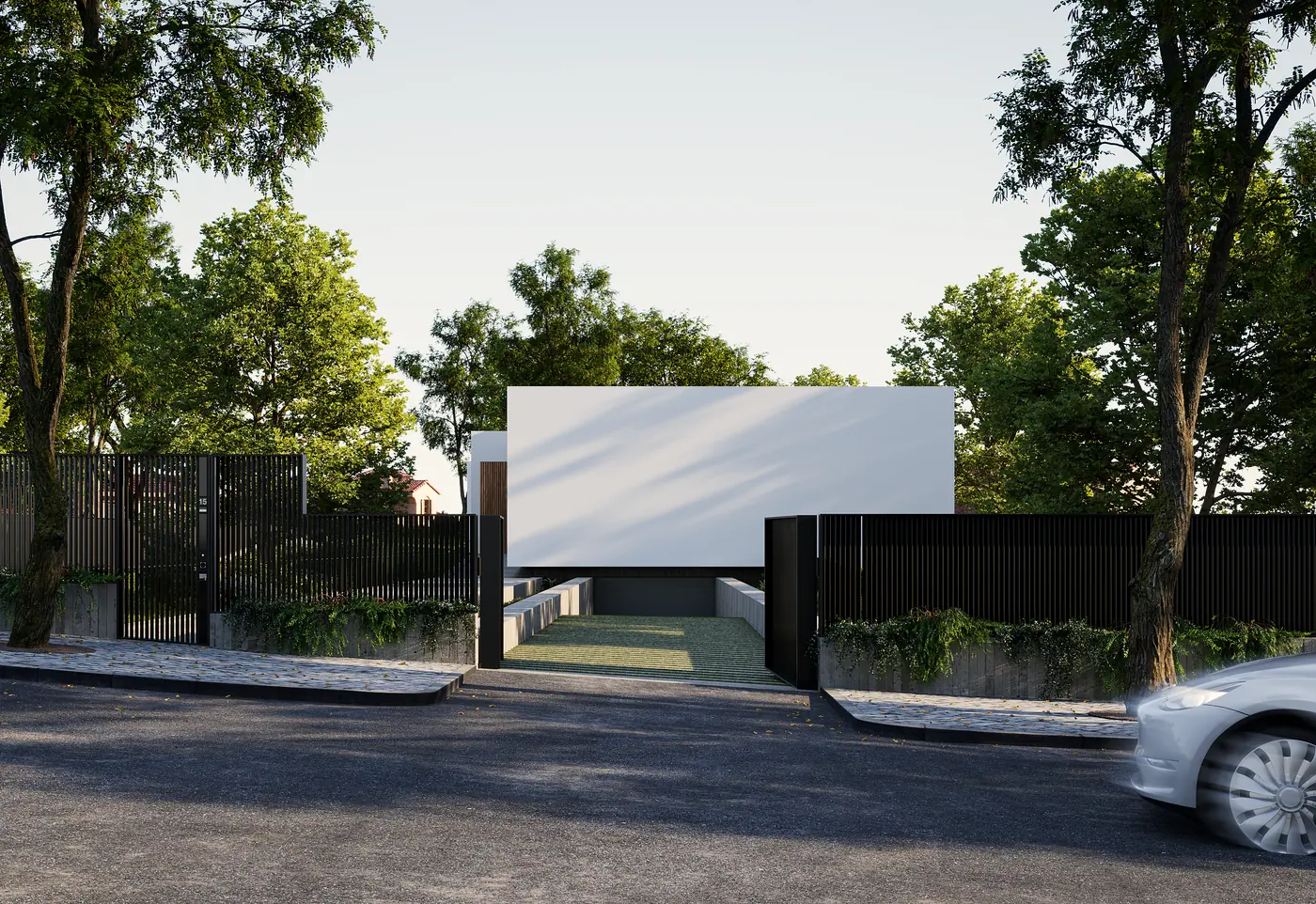 A blank white wall and a dark gate seen from a road, with trees above and a car at the kerb.