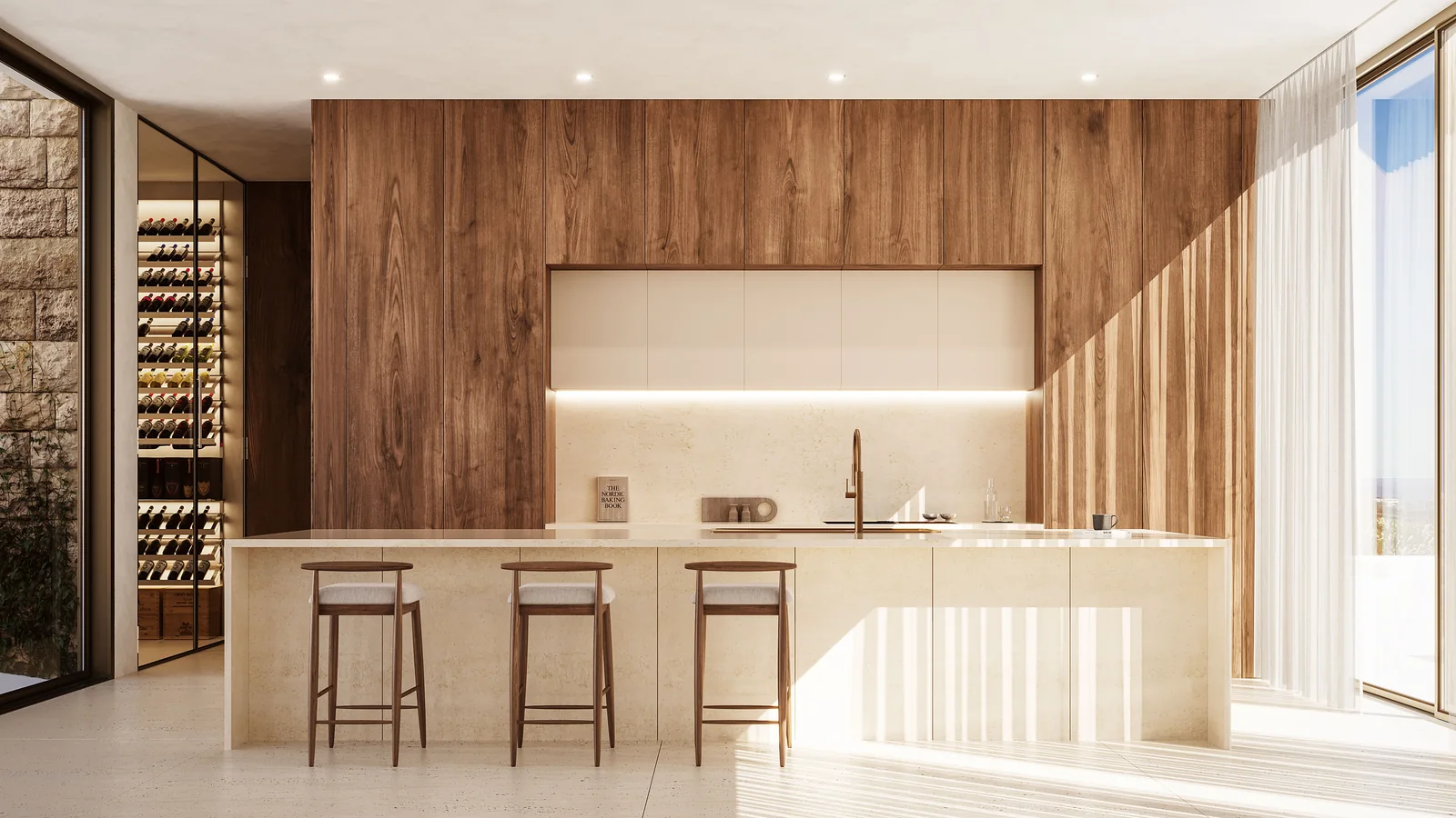 The kitchen: a pale stone island with three stools, a full-height timber wall behind it, integrated units flush with the panelling and a glazed wine store to the left.