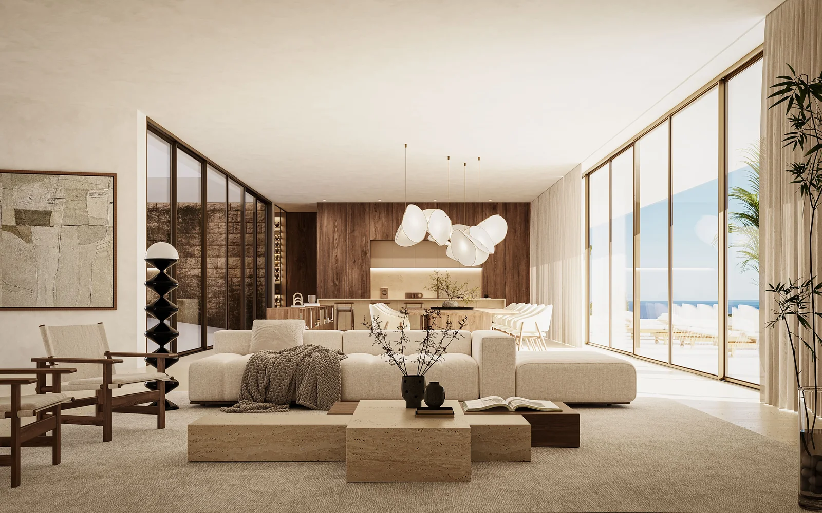 The living room: low pale seating around a stone table, a timber-lined wall to one side, sliding glazing on two sides and the sea at the end of the room.