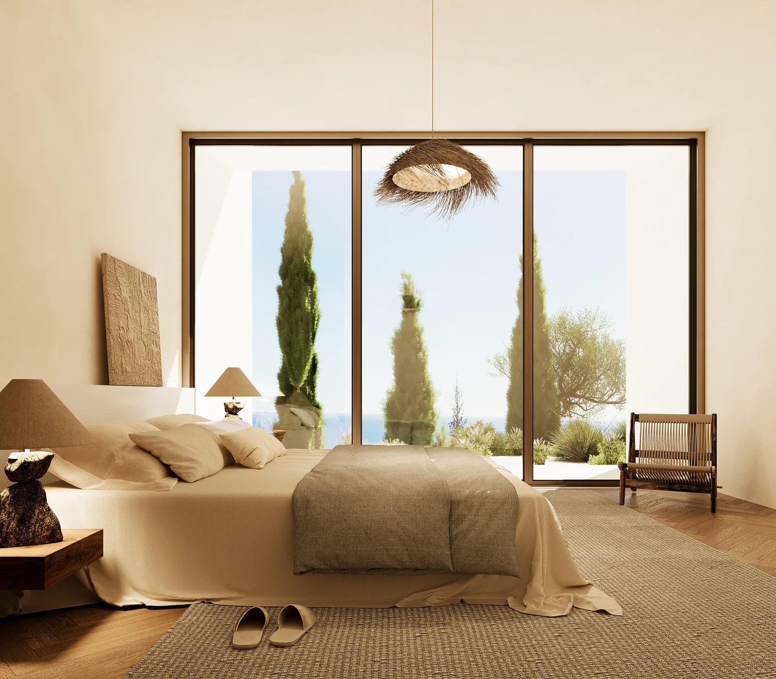 A bedroom with a low bed against a plain wall, a woven pendant to one side, and a sliding glazed door framing two cypresses and the sea.