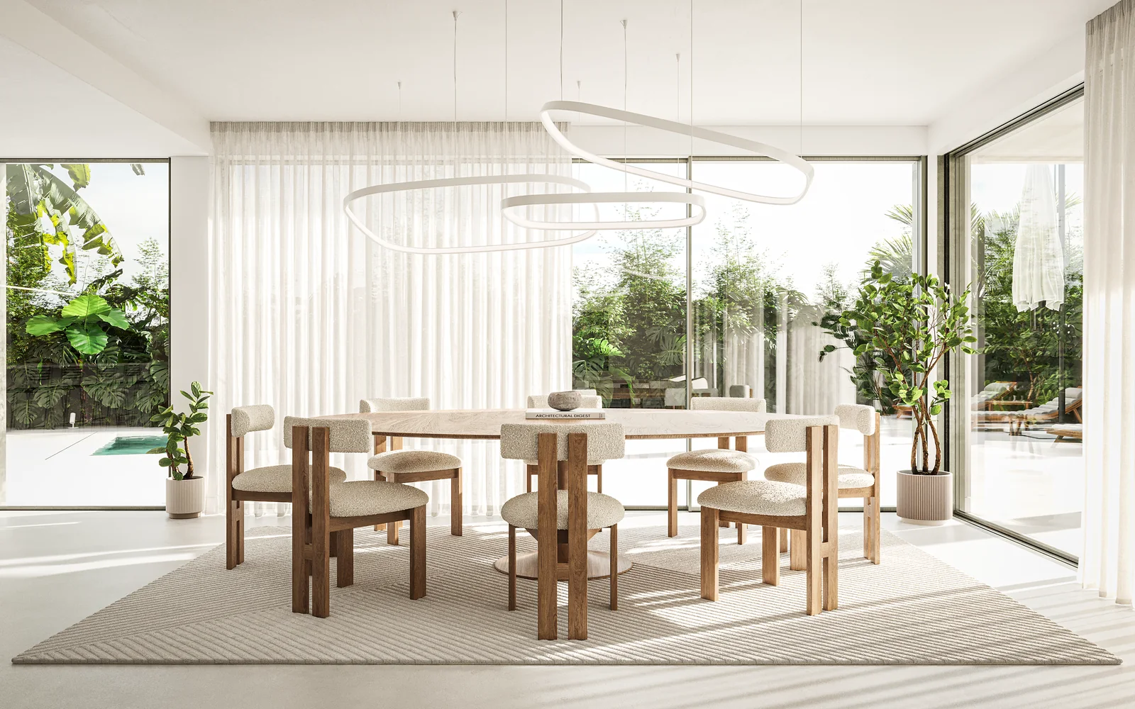A zona de refeições: mesa redonda clara com oito cadeiras sobre um tapete de lã, um grande anel escultórico suspenso por cima, e envidraçado de correr para o terraço da piscina atrás.