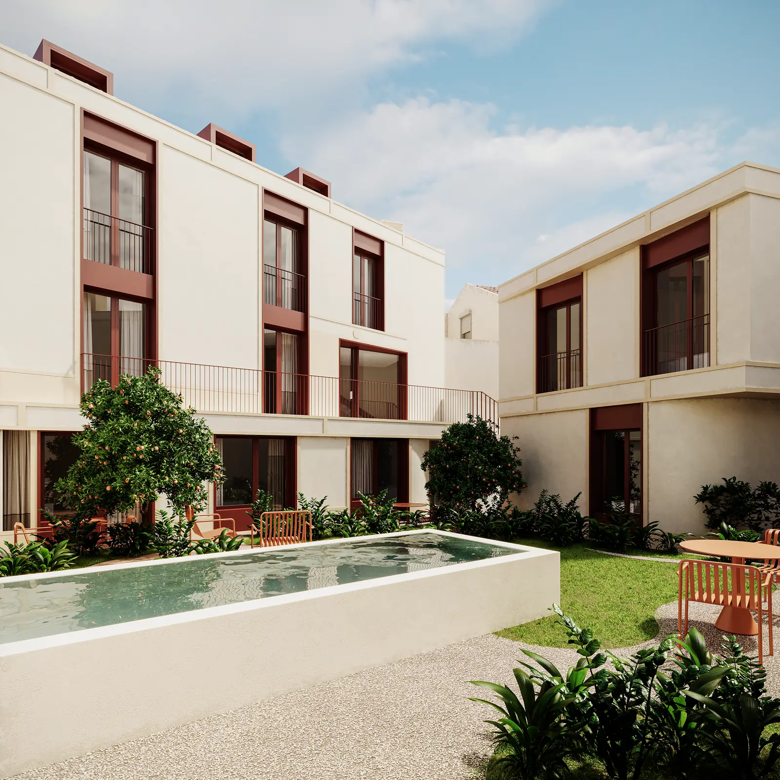 The courtyard seen from the garden end: a long pool along the lawn, planted beds in board-marked concrete, and the three-storey block behind with oxblood window frames set into cream render.