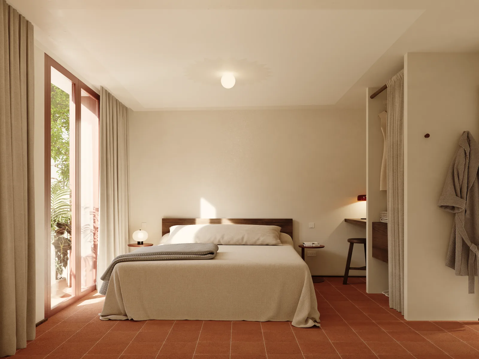 A bedroom with a low bed against a plain plastered wall, a small desk under the window, and a full-height glazed door standing open onto the courtyard.